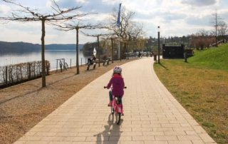 Ein Kind auf dem Fahrrad am Sorpesee im Frühling Ausflugsziel im Sauerland